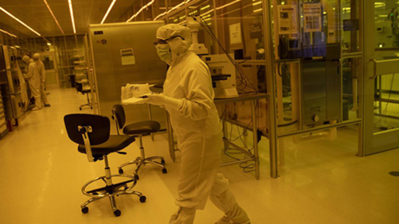 Image of lab worker inside of a nanofabrication facility.