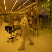 Image of lab worker inside of a nanofabrication facility.
